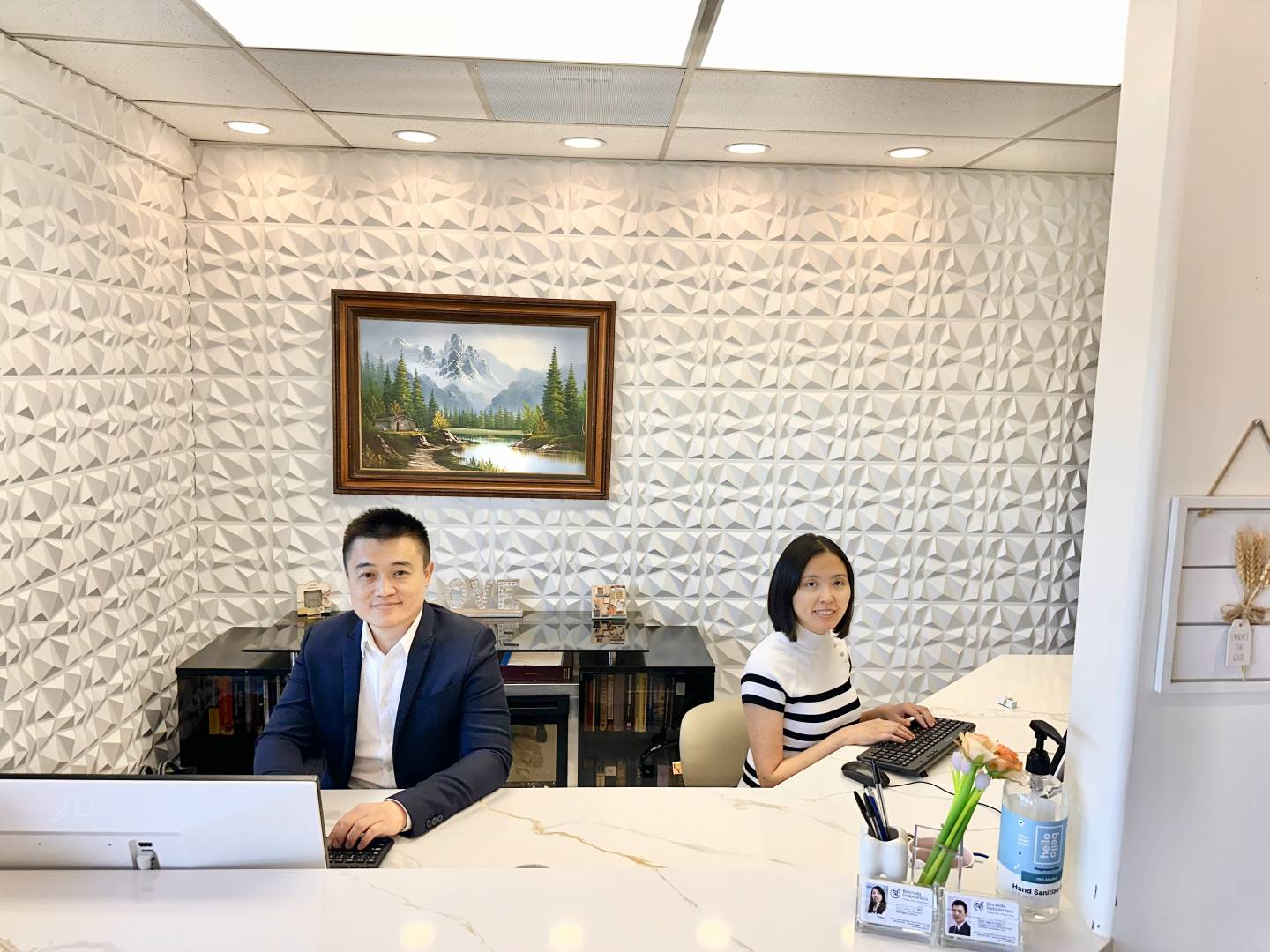 Dr. Ruoxue Feng, DMD, and Dr. Hao Chen, PhD, at the front desk of Biocrede Endodontics.
