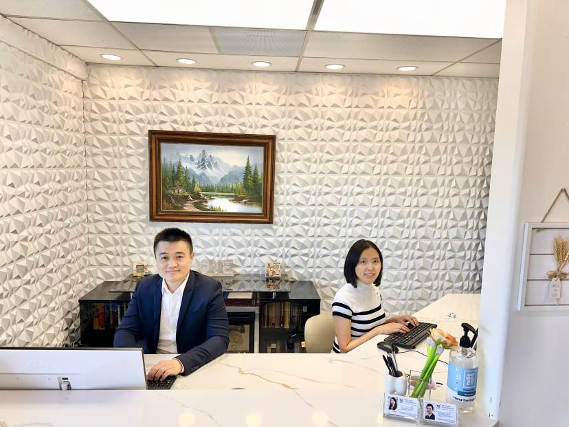 Dr. Ruoxue Feng, DMD, and Dr. Hao Chen, PhD, at the front desk of Biocrede Endodontics.
